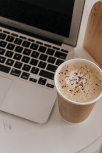 coffee next to a computer.